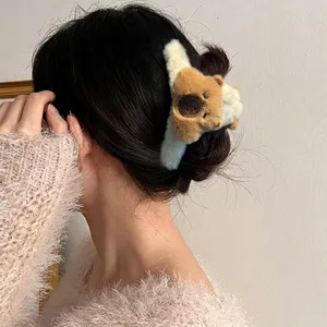 Plush capybara hair claw clip for women in a soft cream and brown design