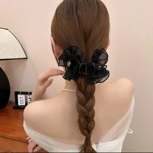 Elegant 8cm black mesh flower hair claw clip displayed on a classic braided hairstyle