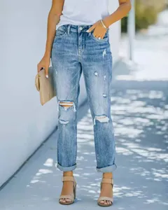 Vue détaillée de jeans déchirés bleus pour femmes avec revers et design élégant tendance.