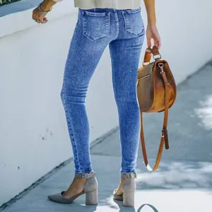 Detailed shot of women's skinny stretch denim jeans, stylish washed blue casual trousers.