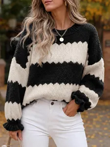 Close-up detail of the black and white color block knit sweater sleeve and texture.