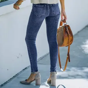Close-up detail view of women's stretch skinny denim jeans, slim fit blue wash casual pants.