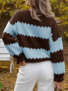 Back view of brown and light blue zigzag knit sweater in autumn park setting detail.