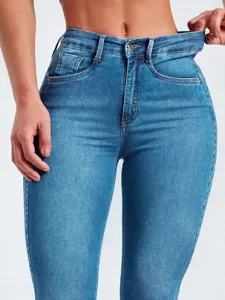 Close-up detail view of women's high-waisted stretchy denim skinny jeans waistband.