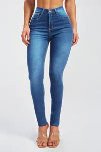 Close-up detail of high-waisted stretchy skinny jeans featuring dark blue wash and slim fit design.