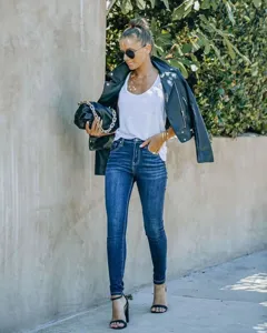 Women's dark blue washed slim fit skinny jeans, stylish street style outfit with jacket.