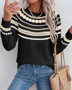 Detailed view of women's long sleeve colorblock knit sweater with geometric striped pattern.
