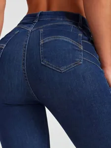 Detail view of women's high-waisted stretchy skinny jeans with shaping back pocket design.