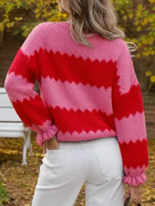 Detail view of women's color-blocked crewneck long sleeve knit sweater top, stylish look.