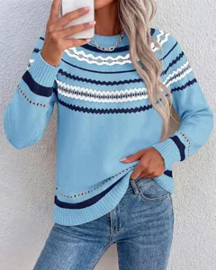 Close-up detail of the stylish light blue Nordic pattern knit sweater sleeves and chest.