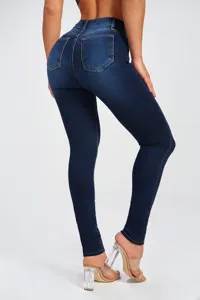 Detail shot of women's dark wash high waist skinny jeans showcasing stretch fit and curves.