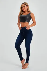 High waist skinny denim jeans paired with black faux leather crop top for women detail view.