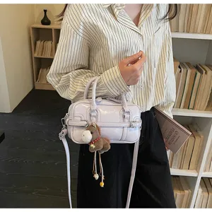 Elegant lavender bowling style handbag for women with a cute plush donkey charm detail