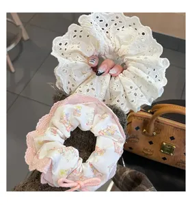 Detalle de coleteros de encaje estilo ballet y estampados de ositos para peinados