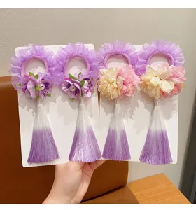 Set of four traditional Chinese style floral hair ties with long gradient purple tassels.