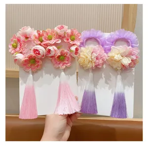 Detail view of traditional Chinese style flower hair scrunchies with long tassels