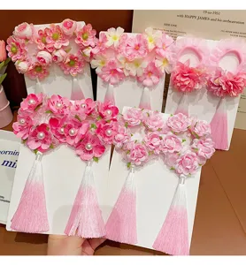 Detailed view of traditional Chinese style floral hair scrunchies with pink tassels