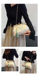 Vintage embroidered handbag details with kiss-lock closure and tassel, model perspective