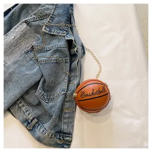 Detailed view of a trendy basketball-shaped mini round crossbody bag with a gold chain strap
