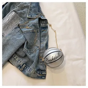 Detailed view of silver basketball shaped mini round crossbody bag with gold chain strap