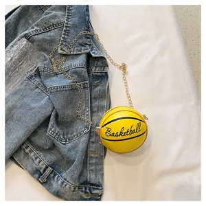 Close-up of a mini yellow basketball-shaped PU leather coin purse with chain.