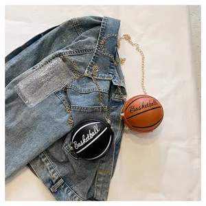 Detail view of stylish black and brown mini basketball chain bags on a denim jacket