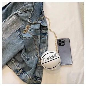 Detailed view of the mini white basketball chain purse showing its compact size next to a phone