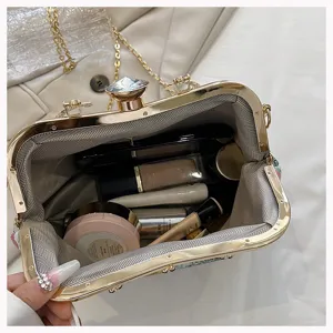 Detail showing the interior capacity of a jacquard floral clutch with cosmetics.
