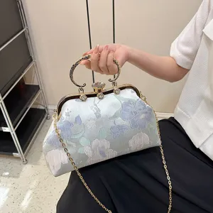 Elegant vintage floral jacquard frame bag with jeweled clasp and gold chain strap