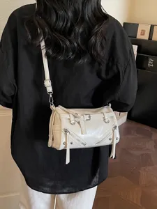 Vintage off-white pillow crossbody bag with belt buckle and metal zipper details