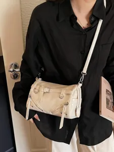 Stylish cream retro soft leather pillow crossbody bag with decorative belt and zippers for women