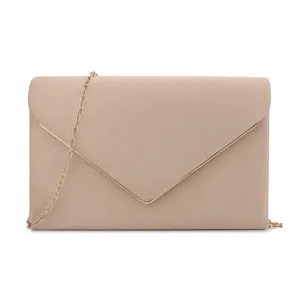 Close-up of elegant apricot suede envelope clutch with gold metal V-trim details