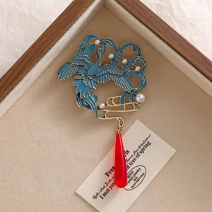 Detail der Brosche im chinesischen Stil mit blauem Emaillekranich und rotem Tropfen
