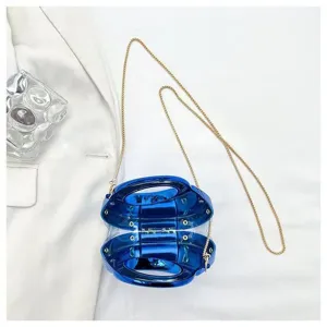 Deep blue acrylic crescent handbag with gold chain strap in a stylish flat lay view
