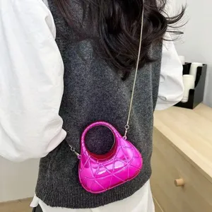 Fuchsia pink geometric quilted hard shell crossbody bag with a slim gold chain strap