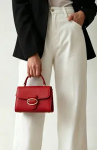 Elegant red pebbled leather handbag with gold oval buckle detail