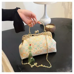 Exquisite vintage style embroidered handbag featuring a gold chain and green tassel detail.