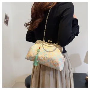 Elegant vintage floral embroidered handbag with a green tassel and gold chain strap