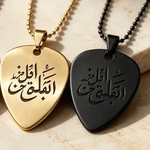 Stainless steel guitar pick necklace detail, engraved Arabic calligraphy pendant jewelry.