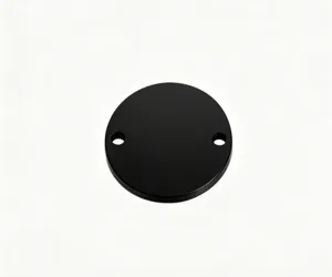 Vue détaillée d'une plaque ronde en métal noir à double trous pour pendentifs et accessoires DIY.