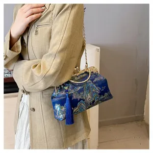 Detailansicht der bestickten Abendtasche mit blauem Quastenanhänger und Goldkette