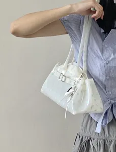Chic white transparent jelly bag featuring green polka dots and a cute white charm