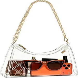 Clear PVC jelly shoulder bag with gold chain showing items inside for capacity detail