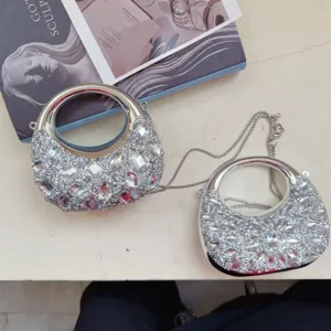 Detailed view of mini rhinestone evening bags with sparkling crystals and silver chain.