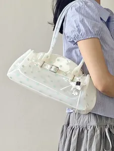 Detail view of transparent jelly shoulder bag with mint green polka dots and star charm.