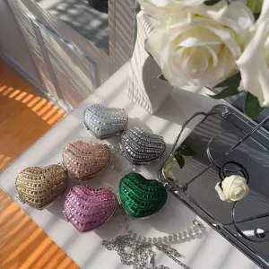Detailed view of luxury heart-shaped rhinestone lipstick bags in multiple vibrant colors.