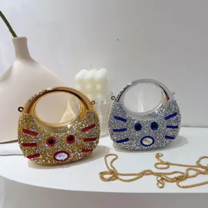 Detailed view of luxury gold and silver mini rhinestone cat-faced evening bags with gold chain