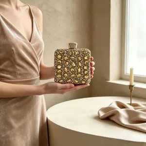 Luxury gold rhinestone evening clutch bag held by a model for elegant gala parties