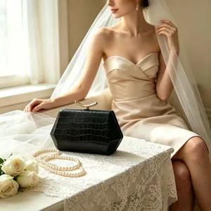 Detail view of black crocodile texture on a hexagonal evening clutch with gold clasp