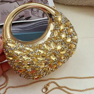 Detail view of gold moon-shaped mini evening bag with amber rhinestones and chain.